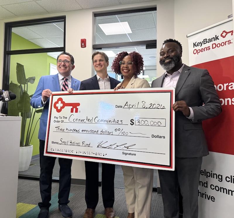 Team members from The KeyBank Foundation present a check for $300,000.