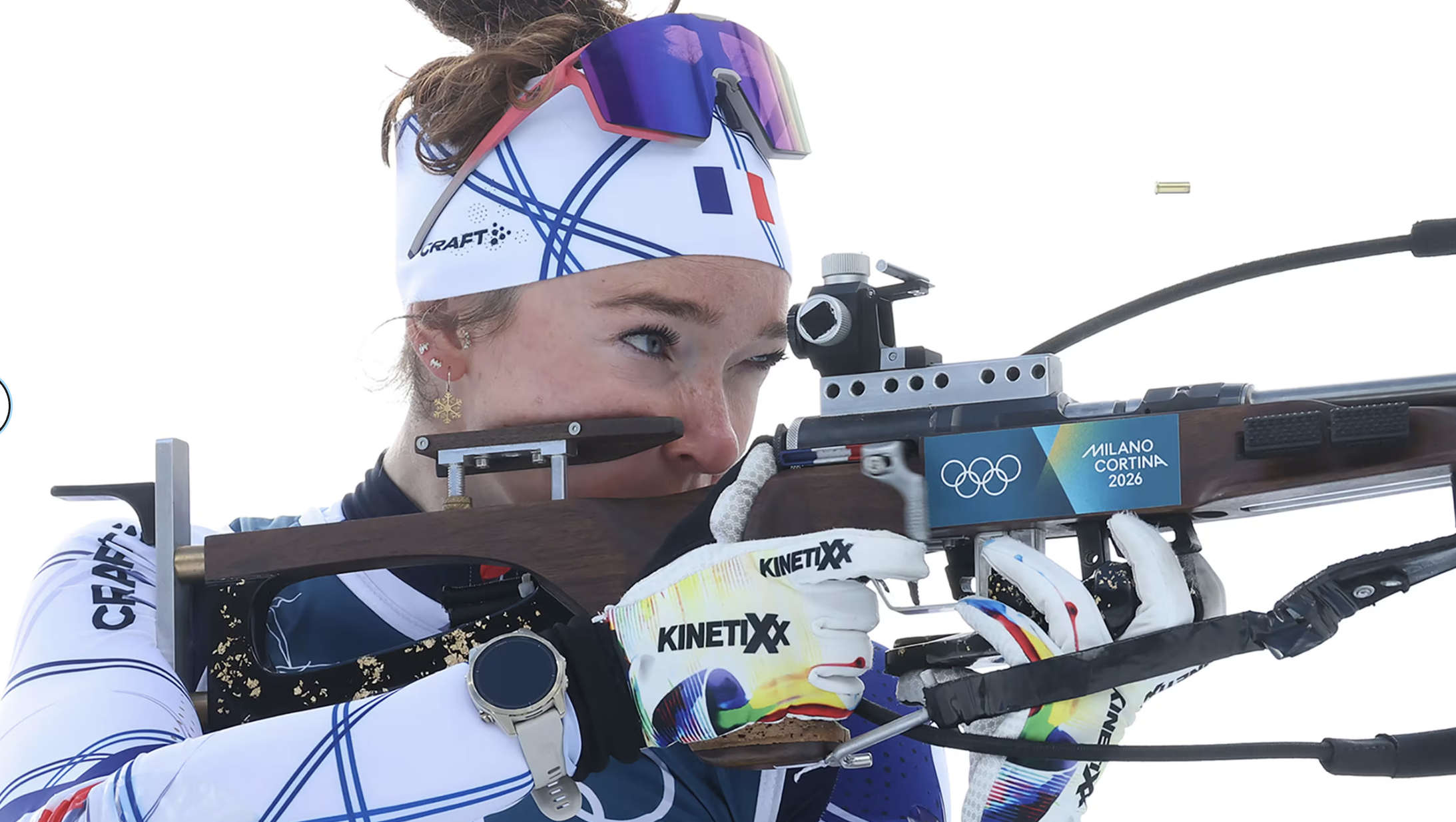woman in Olympic sports gear shooting