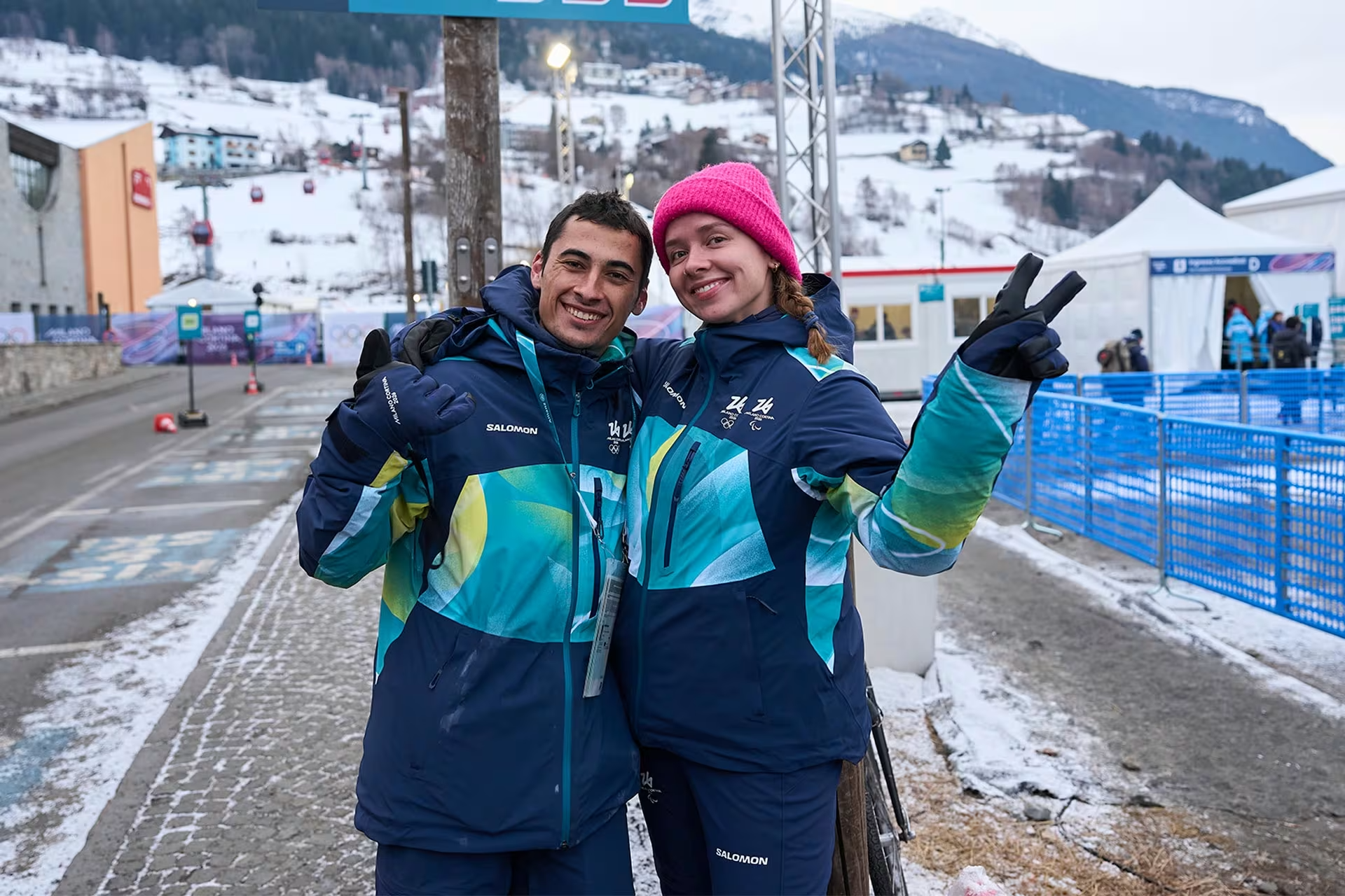 Two smiling athletes in Olympic Village