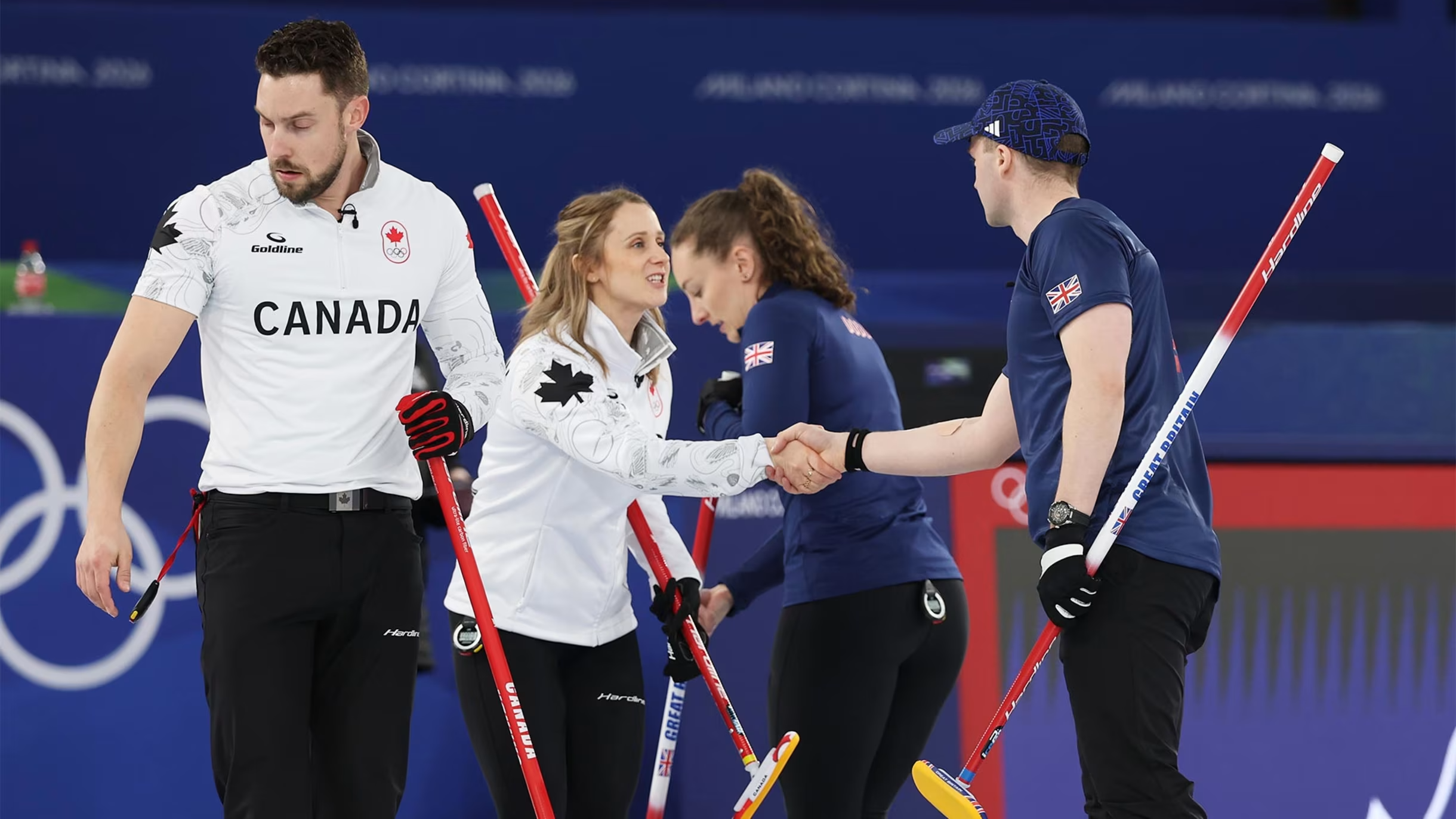 Canadian and British curling teams shaking hands