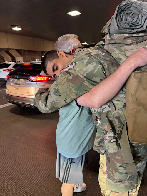 Scott hugging his son.