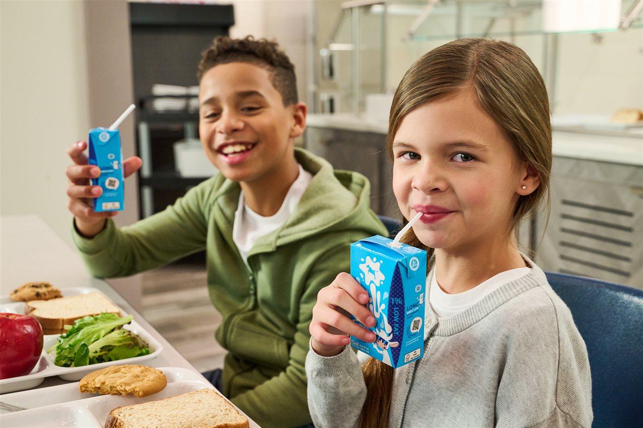 Kids drinking milk out of single-serving boxes