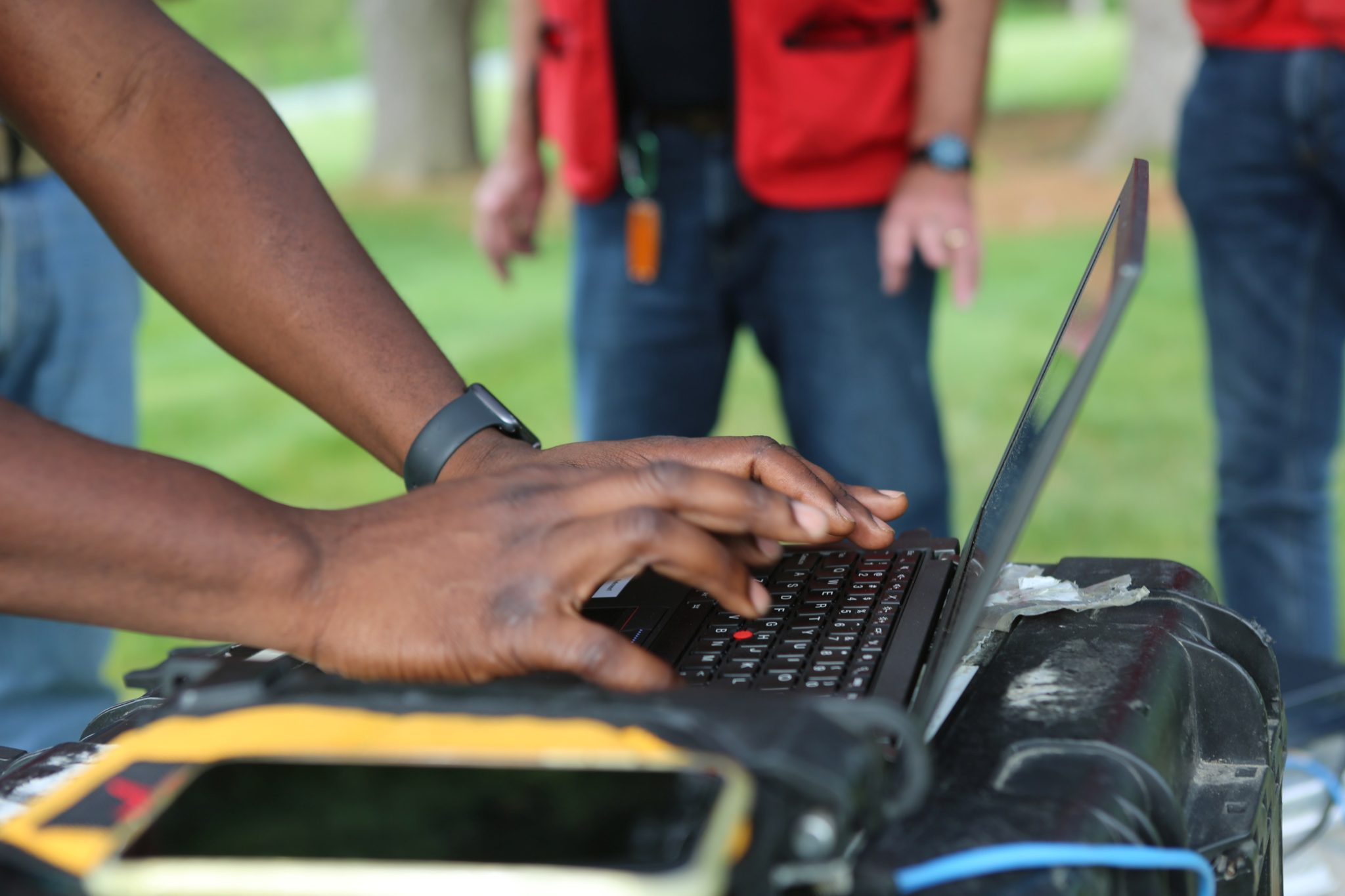 typing on a laptop outside
