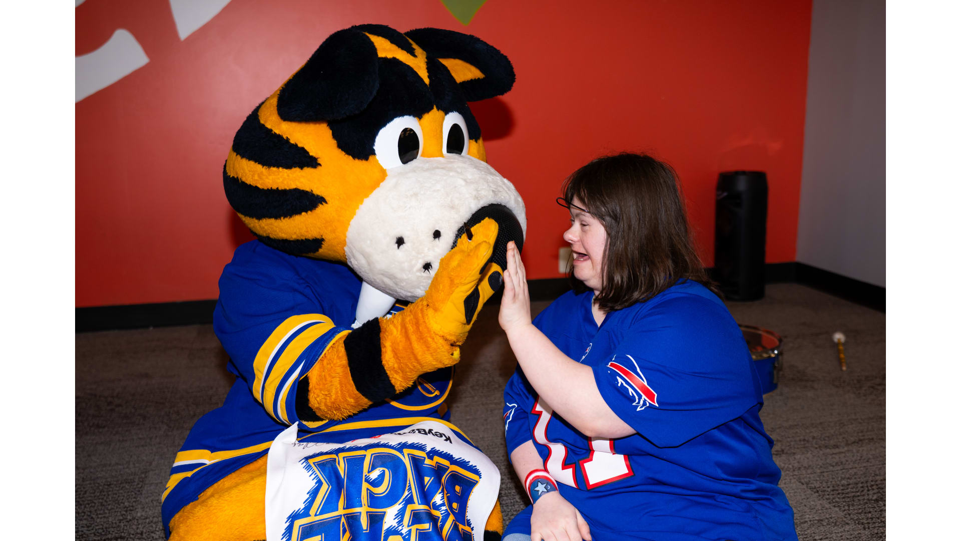 A fan high-fiving Sabres mascot