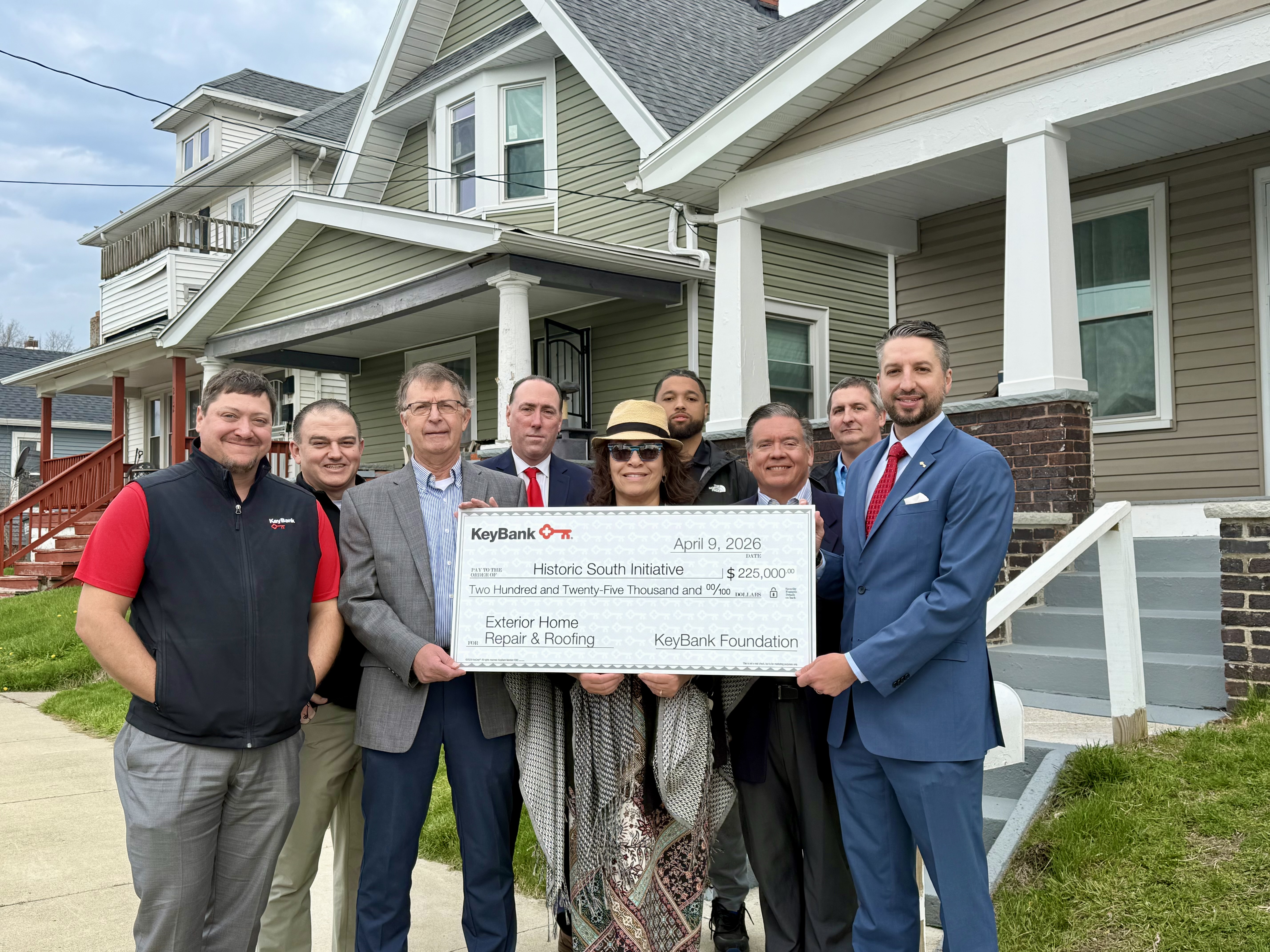 group of people holding up check