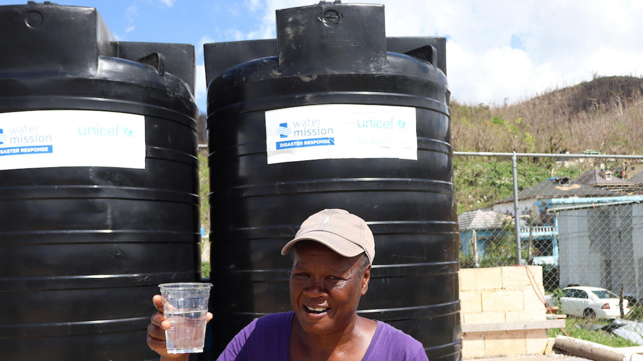 person holding up a cup of water