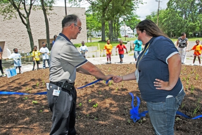 A ribbon is cut to mark the official completion of the rain garden at the Frederick Douglas Community Association in Toledo, Ohio.