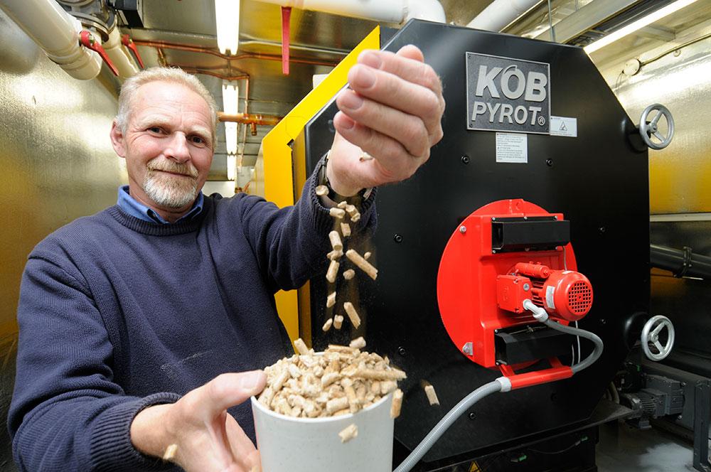 UNBC's Doug Carter presents the chips made from wood waste that help heat the campus